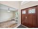 Elegant entryway with hardwood door and floors, with two sitting chairs visible to the left at 3006 Wister Cir, Valrico, FL 33596