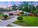 Charming single-story home with lush lawn, mature trees, neutral palette, and a two-car garage at 3006 Wister Cir, Valrico, FL 33596