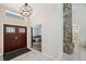 Home foyer featuring a wood door, stone accent wall and open floor plan at 3006 Wister Cir, Valrico, FL 33596