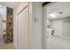 Bright hallway featuring coat closet, laundry room, and stone wall accent at 3006 Wister Cir, Valrico, FL 33596