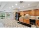 Kitchen with an eat-at island, granite countertops, stainless appliances, and tile backsplash at 3006 Wister Cir, Valrico, FL 33596