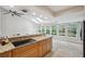 Bright kitchen with granite countertops, cooktop, tile floors, skylights, and views of the yard at 3006 Wister Cir, Valrico, FL 33596
