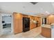 Well-lit kitchen with tile floors, granite countertops, wood cabinets, and stainless steel appliances at 3006 Wister Cir, Valrico, FL 33596