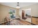 Bright sitting area with wood-look floors, chairs and natural light through a large window at 3006 Wister Cir, Valrico, FL 33596