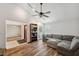 Inviting living room featuring a comfortable sectional sofa, hardwood floors, and a large picture window at 3006 Wister Cir, Valrico, FL 33596