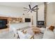 Bright, open living room with stone fireplace, modern furnishings, and bar-height kitchen counter at 3006 Wister Cir, Valrico, FL 33596