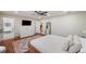 This spacious main bedroom has wood floors, a ceiling fan, and a full bathroom suite at 3006 Wister Cir, Valrico, FL 33596
