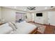Spacious main bedroom features a hardwood floor, a fan, backyard access, and ensuite bathroom at 3006 Wister Cir, Valrico, FL 33596