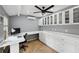 Bright home office features a ceiling fan, tile flooring, and built-in cabinets at 3006 Wister Cir, Valrico, FL 33596
