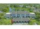 Wide aerial view of the multi-Gathering home with carport parking and well manicured landscaping at 33 Bishops Court Rd # 118, Osprey, FL 34229
