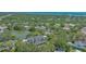 Aerial view of the property showcasing its proximity to a serene pond and lush green surroundings at 33 Bishops Court Rd # 118, Osprey, FL 34229