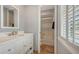 Bathroom features a white vanity with chrome faucet and walk-in shower at 33 Bishops Court Rd # 118, Osprey, FL 34229