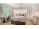 Bright bedroom with a ceiling fan, a writing desk, and integrated bookshelves and storage at 33 Bishops Court Rd # 118, Osprey, FL 34229