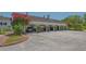 A multi-car carport shows parking for residents, surrounded by lush green landscaping at 33 Bishops Court Rd # 118, Osprey, FL 34229