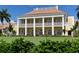 The grand clubhouse features expansive windows and a terrace overlooking the manicured lawn at 33 Bishops Court Rd # 118, Osprey, FL 34229