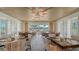Dining room with large windows overlooking the golf course, creating a serene and scenic dining environment at 33 Bishops Court Rd # 118, Osprey, FL 34229