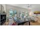 Bright dining area featuring a large glass-top table and sliding glass doors to a patio area at 33 Bishops Court Rd # 118, Osprey, FL 34229