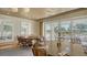 Dining room with large windows overlooking the golf course, creating a serene and scenic dining environment at 33 Bishops Court Rd # 118, Osprey, FL 34229