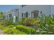 Charming entryway featuring flowering plants and shrubbery leading to the home's front door at 33 Bishops Court Rd # 118, Osprey, FL 34229