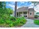 Cozy home exterior surrounded by lush landscaping and mature trees at 33 Bishops Court Rd # 118, Osprey, FL 34229