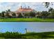 Beautiful exterior view of a large home overlooking a golf course and lake, surrounded by lush landscaping at 33 Bishops Court Rd # 118, Osprey, FL 34229