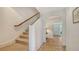 Bright foyer with tiled floor, staircase, and an arched doorway leading to other living spaces at 33 Bishops Court Rd # 118, Osprey, FL 34229