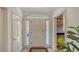 Bright foyer featuring arched transom window, white trim and tile flooring at 33 Bishops Court Rd # 118, Osprey, FL 34229