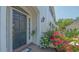 Inviting entrance with well-lit doorway surrounded by flowers, creating a warm welcome at 33 Bishops Court Rd # 118, Osprey, FL 34229