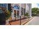 Elegant front entrance features classic columns, potted plants, and decorative fall wreaths at 33 Bishops Court Rd # 118, Osprey, FL 34229