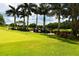 View of golf carts parked on the course, surrounded by lush greenery at 33 Bishops Court Rd # 118, Osprey, FL 34229