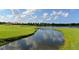 Scenic view of the golf course and serene lake, highlighting the community's natural beauty and landscaping at 33 Bishops Court Rd # 118, Osprey, FL 34229