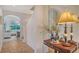 Elegant hallway with a large mirror and arched entryway to the living room at 33 Bishops Court Rd # 118, Osprey, FL 34229
