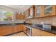 Well-equipped kitchen with granite countertops, stainless steel appliances, and custom wood cabinets at 33 Bishops Court Rd # 118, Osprey, FL 34229