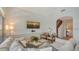 Comfortable living room with a large sectional sofa and stylish decor leading to the stairway at 33 Bishops Court Rd # 118, Osprey, FL 34229