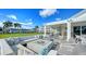 Outdoor patio with comfortable seating and a modern fire pit overlooking the golf course and building at 33 Bishops Court Rd # 118, Osprey, FL 34229