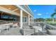 Outdoor patio with comfortable seating, columns, and views of the golf course and bar at 33 Bishops Court Rd # 118, Osprey, FL 34229