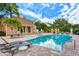 Beautiful community pool with lounge chairs and tables for residents to relax and enjoy at 33 Bishops Court Rd # 118, Osprey, FL 34229