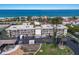 Stunning aerial view of a beachfront condo community with tropical landscaping and convenient parking at 3320 Gulf Of Mexico Dr # 307C, Longboat Key, FL 34228
