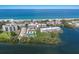 Aerial view of the condo community with water views and near the beach on a sunny day at 3320 Gulf Of Mexico Dr # 307C, Longboat Key, FL 34228