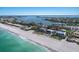Picturesque waterfront neighborhood with a sandy beach and turquoise waters, ideal for a relaxing lifestyle at 3320 Gulf Of Mexico Dr # 307C, Longboat Key, FL 34228