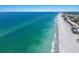 Stunning aerial view of the coastline, showing beachside community, and vibrant turquoise water at 3320 Gulf Of Mexico Dr # 307C, Longboat Key, FL 34228