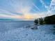 Picturesque beachfront scene with a bench, ideal for enjoying peaceful sunsets and ocean breezes at 3320 Gulf Of Mexico Dr # 307C, Longboat Key, FL 34228