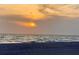 Beautiful beach view with the sun kissing the horizon, promising serene evenings by the sea at 3320 Gulf Of Mexico Dr # 307C, Longboat Key, FL 34228