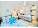 Coastal bedroom with two twin beds, nautical themed decor and a ceiling fan at 3320 Gulf Of Mexico Dr # 307C, Longboat Key, FL 34228