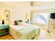 Comfortable bedroom features a queen bed, light wood floors, and a ceiling fan, offering a relaxing space at 3320 Gulf Of Mexico Dr # 307C, Longboat Key, FL 34228