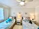 Charming bedroom with two beds, sea-themed decor, ceiling fan, perfect for children or guests, ensuring a delightful stay at 3320 Gulf Of Mexico Dr # 307C, Longboat Key, FL 34228