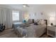 Bright bedroom featuring two twin beds adorned with plush sea creature toys and soft, inviting gray bedding at 3320 Gulf Of Mexico Dr # 307C, Longboat Key, FL 34228