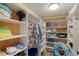 Organized closet with shelves, hanging storage, and personal items for a neat space at 3320 Gulf Of Mexico Dr # 307C, Longboat Key, FL 34228