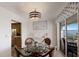 A dining area featuring a glass-top table with seating for four, connecting to a bright kitchen and a scenic balcony at 3320 Gulf Of Mexico Dr # 307C, Longboat Key, FL 34228