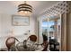 Dining area with a glass table, seating, and a balcony view, perfect for enjoying meals with a scenic backdrop at 3320 Gulf Of Mexico Dr # 307C, Longboat Key, FL 34228